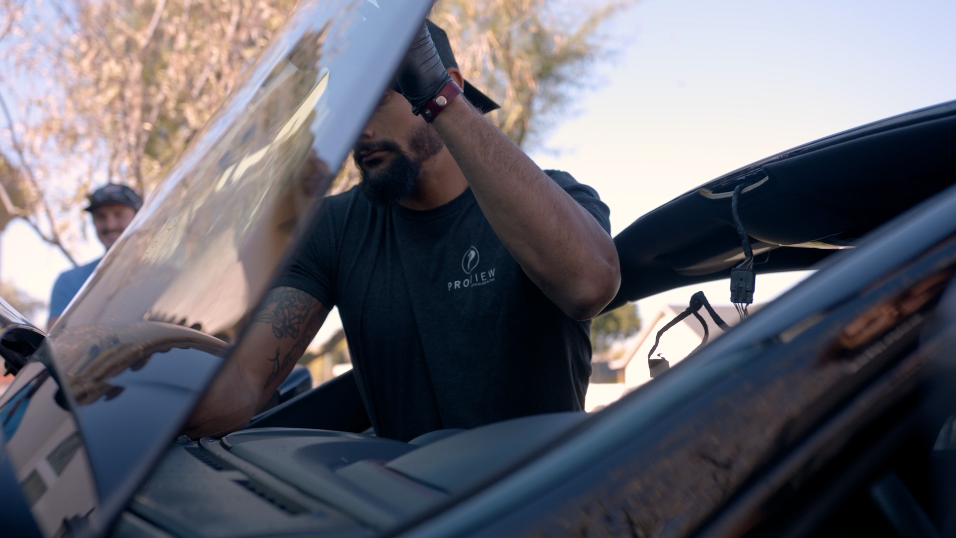 A ProView crew lifting a replacement windshield into place