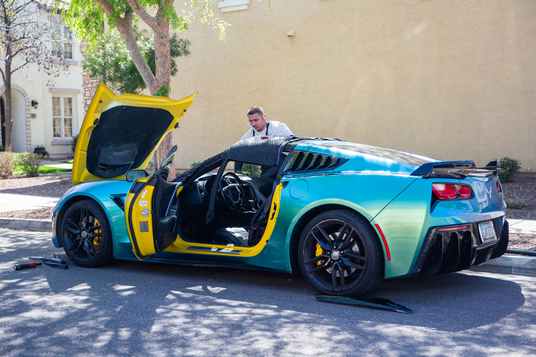 A ProView technician working on a customer's car in their driveway